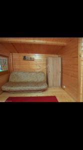 a bedroom with a bed in a wooden cabin at Domki letniskowe Wrzoski in Kamień Pomorski