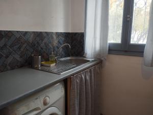 a kitchen with a sink and a washing machine at White Cat in Vromolithos +36 photos