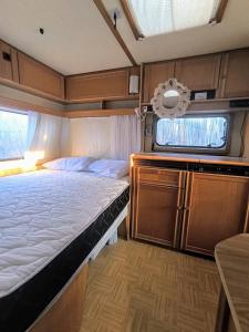 a bedroom with a large bed and a window at Каравана The Jungle in Chernomorets