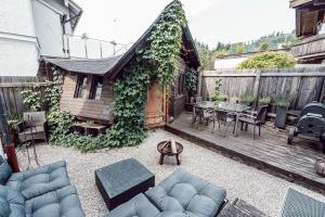 a patio with a table and chairs on a wooden deck at Alpenrausch 1 in Kiefersfelden