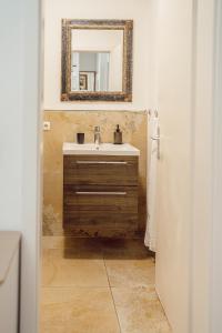 a bathroom with a sink and a mirror on the wall at Alpenrausch 1 in Kiefersfelden +8 photos