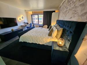 a bedroom with a large bed and a couch at Lazy Olives in Tongeren +37 photos