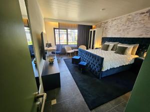a bedroom with a bed and a couch and a desk at Lazy Olives in Tongeren