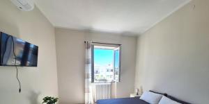 a white room with a bed and a window at Casa Dolce Casa in Termoli