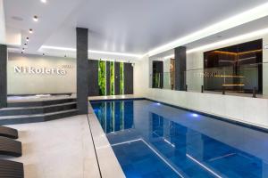 a swimming pool in the middle of a building at Villa Nikoletta SPA in Bukovel