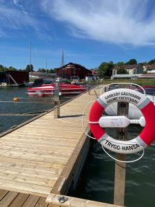 a boat is docked at a dock at Hamnvaktsbostaden in Gamleby