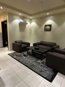 a living room with two couches and a coffee table at كيان الين للشقق المخدومة in Abha +2 photos
