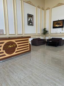 een lobby met een open haard en banken in een kamer bij New Elite المنسك الجديد in Abha