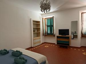 a bedroom with a bed and a flat screen tv at Casa Paola in Pontremoli