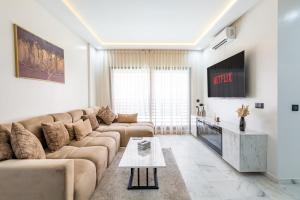 a living room with a couch and a tv at Cocoon in Gueliz, Netflix, IPTV in Marrakech +38 photos