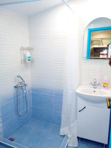 a bathroom with a shower and a sink at Jazzy Art Home in Sofia +9 photos