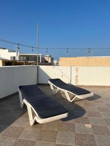 two beds on the roof of a building at Spacious house with roof-terrace in Mellieħa