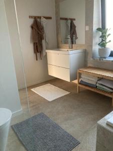 a bathroom with a sink and a mirror at Casa Sol e Mar - Family stays in Torres Vedras