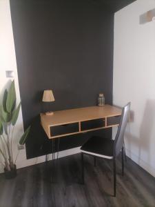 a desk with a chair and a desk with a lamp at Moderne Jacuzzi Terrasse in Narbonne +16 photos