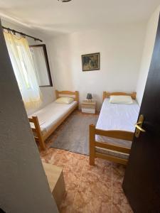 a bedroom with two beds and a window at Bigova Peace Oasis in Bigovo