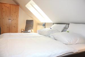 a bedroom with two beds with white pillows at Villa Brodthage, App. 1 in Walkenried