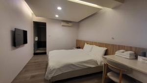 Posteľ alebo postele v izbe v ubytovaní Xingyi Hotel