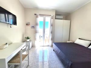 a bedroom with a bed and a table and a door at Casa Dolce Casa in Termoli