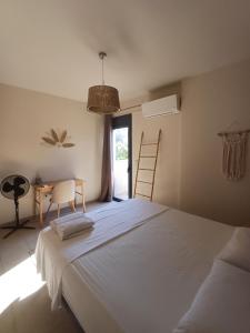 a bedroom with a large white bed and a desk at Pool apartment 5 minutes walk from beach in Porto Rafti +38 photos