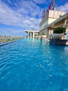 a pool on the roof of a building with blue water at LuxePink Teddd Jucuzzi Studio-PrivatePatio in Gurgaon