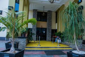 a lobby with potted plants in front of a building at Zoey International Hotels Ltd in Owerri