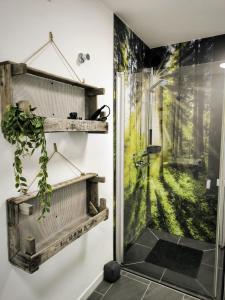 a bathroom with a shower with a glass door at Tor zum Saueland mit Sauna und Whirlpool in Olpe