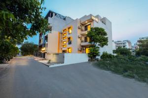a building on the side of a road at Limewood stay premier golf course road -sector 42 in Gurgaon