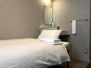 Postel nebo postele na pokoji v ubytování Hotel Gee Haive