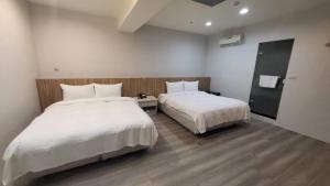 Posteľ alebo postele v izbe v ubytovaní Xingyi Hotel
