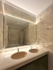 ein Badezimmer mit zwei Waschbecken und einem großen Spiegel in der Unterkunft inluz apartment in Vila do Conde