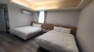 Posteľ alebo postele v izbe v ubytovaní Xingyi Hotel