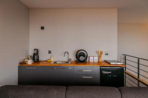 a kitchen with a counter and a sink and a couch at PANA Sapanca Lake View in Sapanca