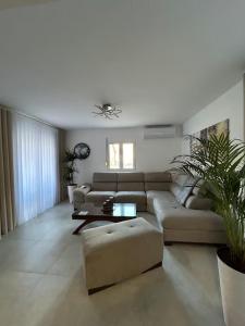a living room with a couch and a table at Asia Apartments in Škaljari