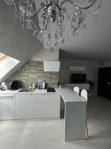 a kitchen with a chandelier hanging from a ceiling at Residensia Bahami in Sunny Beach