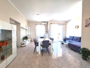 a living room with a table and a blue couch at Casa Dolce Casa in Termoli