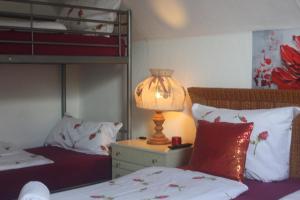 a bedroom with two beds and a lamp on a night stand at Harzspaß in Braunlage