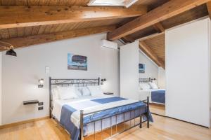 a bedroom with a large bed and wooden ceilings at Villa Al Borgo - Villa with Private Garden in Salerno