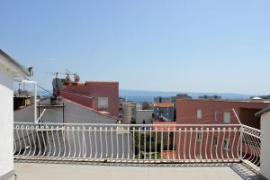 a balcony with a white railing on a building at Azizam hostel in Split +7 photos