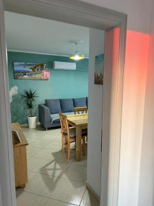 a living room with a table and a couch at Mali i Robit SeaView Apartment in Golem