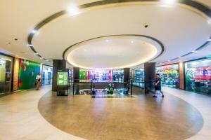 a lobby of a building with a large circular ceiling at Urban Luxe 1BR Makati central gym swim Park Fast Internet MB 3301 in Manila +52 photos