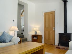 a living room with a couch and a wood stove at The Cottage in Cheltenham