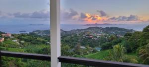 a view of the ocean from a house balcony at WindBlow Villa in Belmont