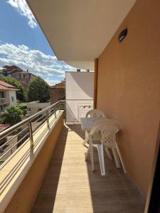 a balcony with a table and chairs on a building at M&D in Nesebar