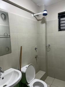 a bathroom with a toilet and a sink and a shower at Qwetu in Thika