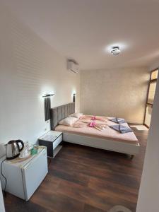 a bedroom with a bed with a pink ribbon on it at M&D in Nesebar