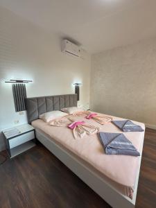 a large bed with two towels on it in a bedroom at M&D in Nesebar