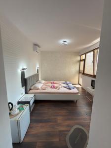 a bedroom with a bed with a pink ribbon on it at M&D in Nesebar +64 photos