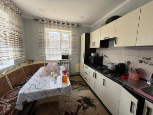 a kitchen with a table in the middle of it at Dostuk in Naryn