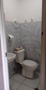 a bathroom with a toilet and a sink at AMS Hostel Butuan City in Butuan +18 photos