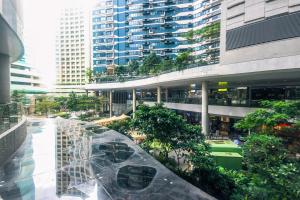 a view of a building with trees and buildings at City Best Designer 1BR Makati Fast internet Gym Swim Park 2050 in Manila